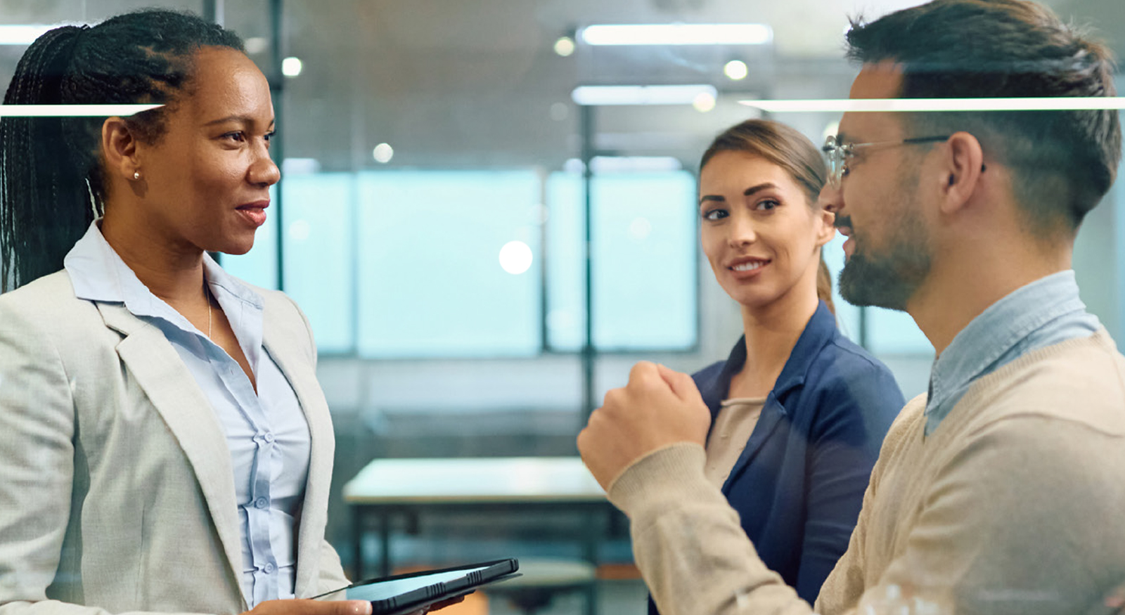 Association professionals discussing strategies outside a meeting room